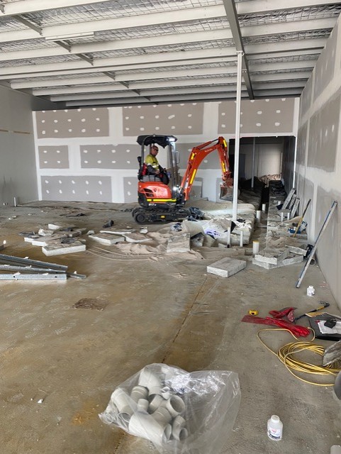 Caremore Pharmacy — During · below-floor plumbing excavation