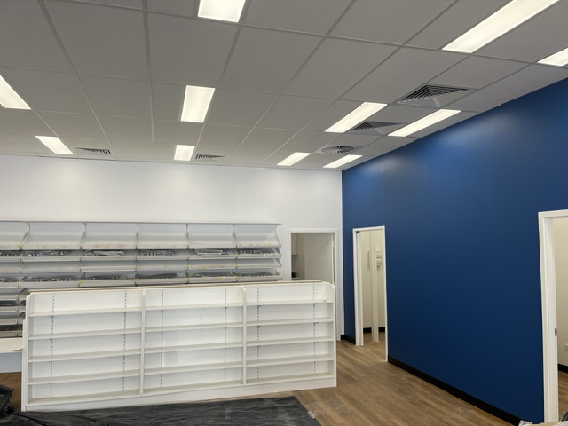Caremore Pharmacy — During · retail shelving installation