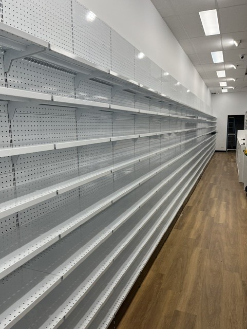 Caremore Pharmacy — During · completed wall shelving