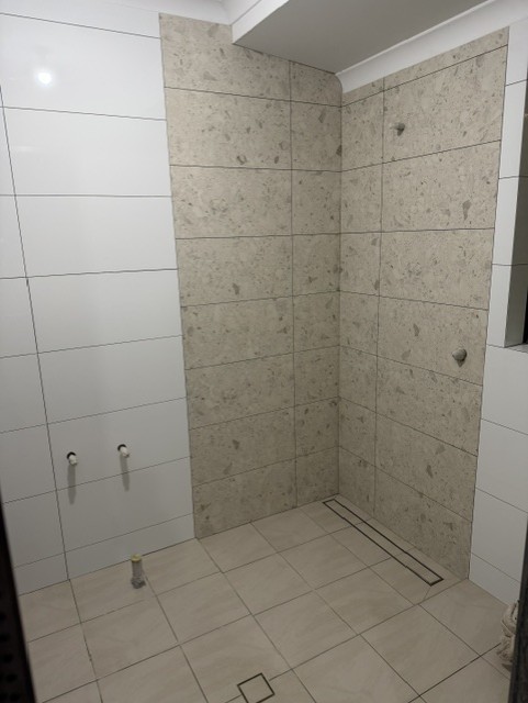 Residential Ensuite — During · wall and floor tiling